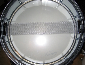 The wires of a snare drum