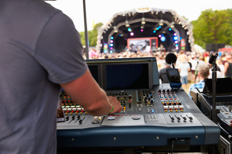 Sound and lighting engineer at an outdoor festival concert