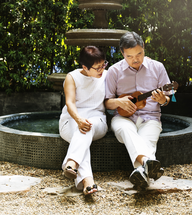 Senior Couple Fountain Ukelele Instrument Concept