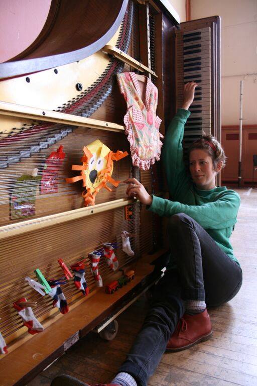 Sarah with piano and children's art