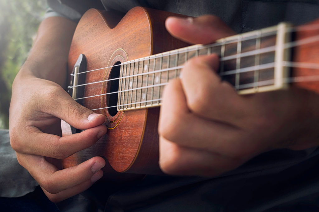 Ukulele being strummed