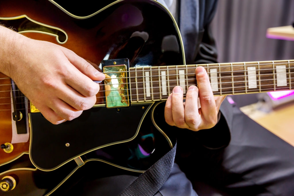 Arpegiatted guitar chord being played