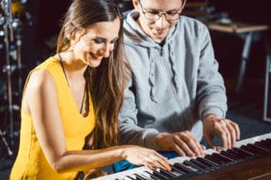 adult friends having fun at the piano.jpeg