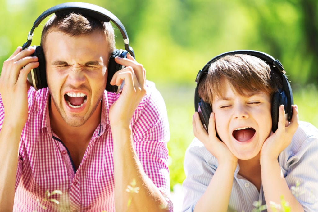 Father and son listening to music