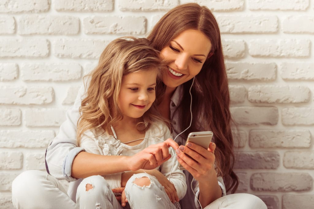 Mother and daughter enjoying music together