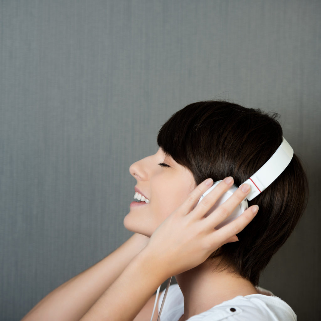 Young woman actively listening to music